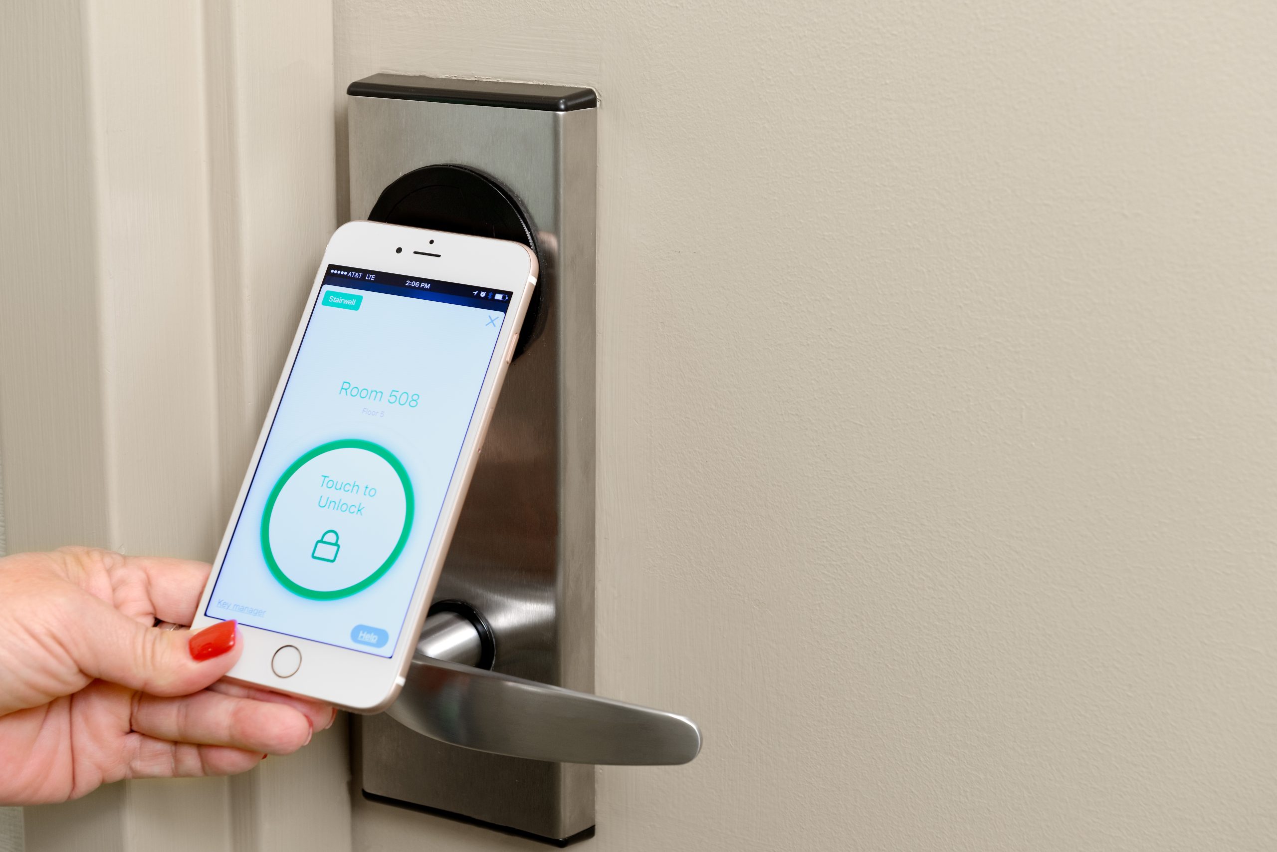 A guest using their phone as a digital key on their door